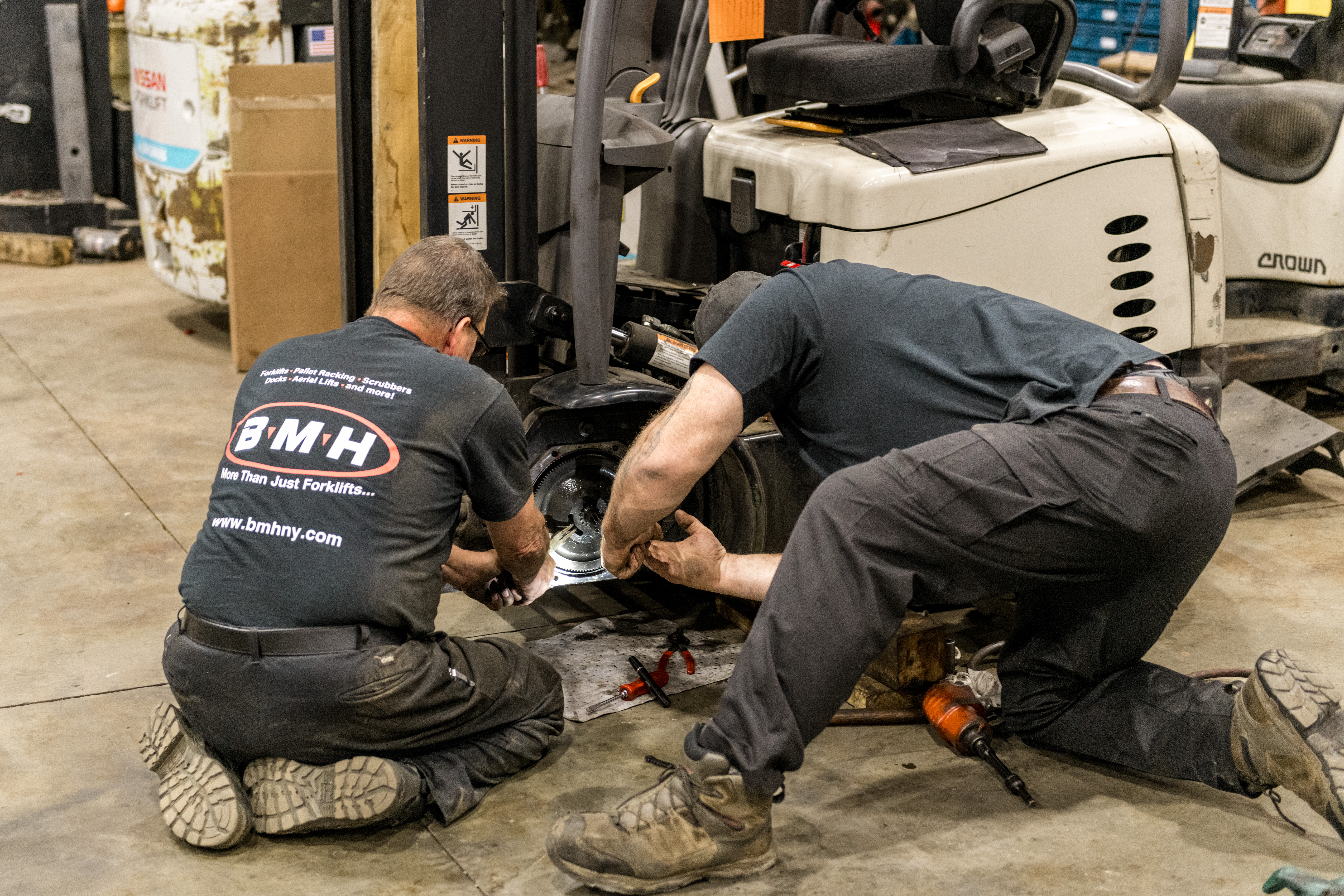 BMH technicians performing forklift wheel repair – Expert forklift service and maintenance in Western NY